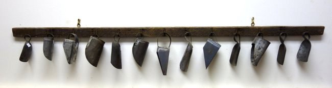 Grouping of 13 tin scoops artistically arranged on a (1 of 4)