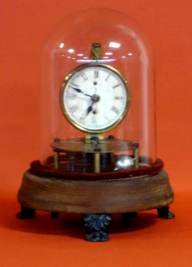 Unusual clock under dome on wooden base with claw feet. (1 of 4)