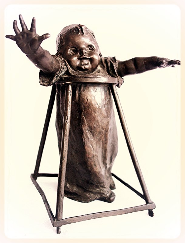 Bronze sculpture of baby in walker, signed Joan Clara: Bronze sculpture of baby in walker, signed Joan Clara (Spanish 1875-1957). 9"H. Good patina in excellent condition.