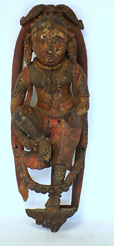Carved wooden Indian sculpture of a goddess in original: Carved wooden Indian sculpture of a goddess in original darkened polychrome paint. Loss to left hand, stress hairline down front and back of head, ,minor surface chips, otherwise good condition. 25"H.