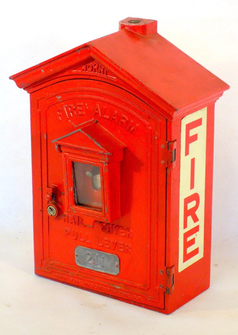 Old cast iron firebox with original clock works, in the: Old cast iron firebox with original clock works, in the shape of a building - locked front door with key and glass panel - signed Horni. Excellent condition. 17"H x 10.75"W x 5"D. Original red paint. 
