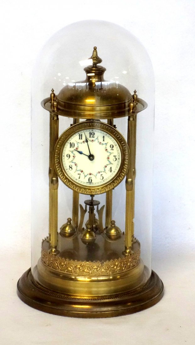 Fancy brass anniversary clock with hand painted floral: Fancy brass anniversary clock with hand painted floral face signed Germany. Original glass dome. Good condition. Has not been tested for working order. 17"H.