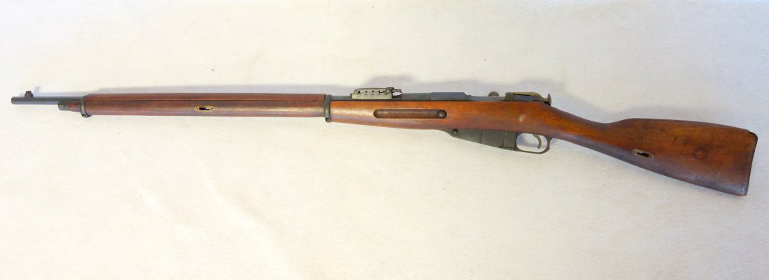 Military bolt action Mosin-Nagant Model 1891 rifle: Military bolt action Mosin-Nagant Model 1891 rifle signed New England Westinghouse Company 1915. Serial numbers 12298807 match on receiver, bolt and butt plate. The rifle was manufactured by the afore