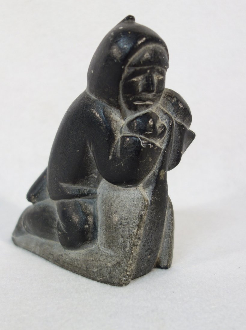Inuit stone carving depicting Eskimo hauling stylized: Inuit stone carving depicting Eskimo hauling stylized animal across back. Signed on base Mattawpica Kope - #24927. Minor surface abrasions, otherwise very good condition.