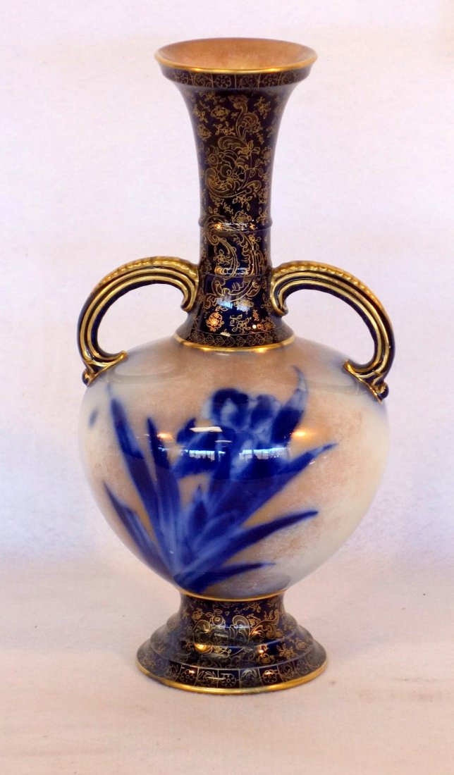 Double handle vase decorated with gold and cobalt blue: Double handle vase decorated with gold and cobalt blue decorations on base, handles and neck, body with flow blue flowers. Signed Doulton Burslem England. 12.75"H. Excellent condition. No chips, crack