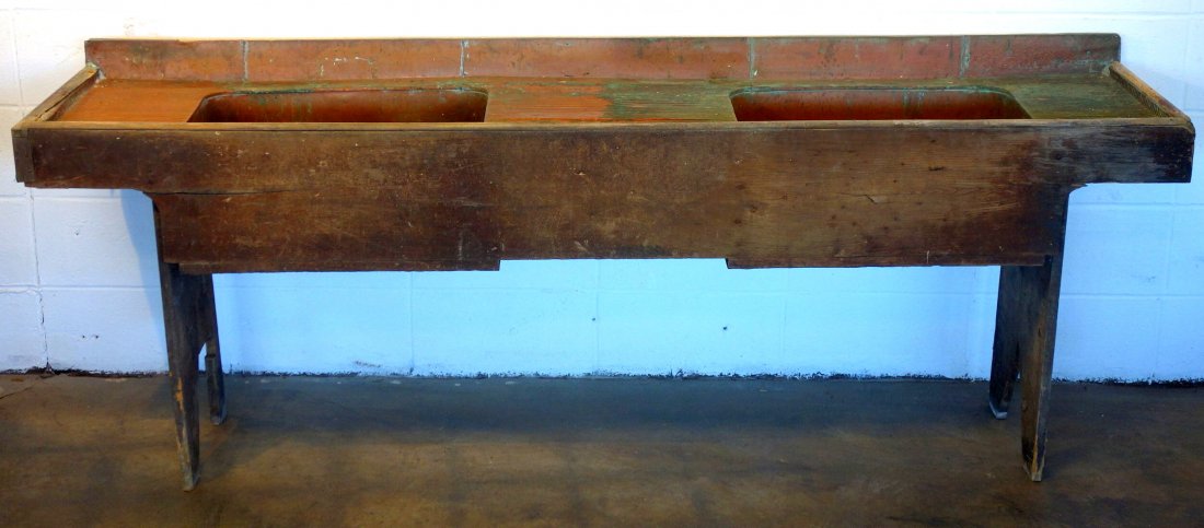 Large country copper lined wooden double sink with boot: Large country copper lined wooden double sink with boot jack ends - copper drain board on both sides - copper backsplash. Late 19th century. 84"L x 19"D x 31"H. Very good condition.