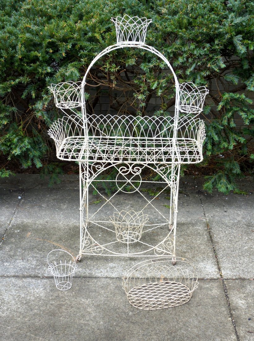 Unusual Victorian wire planter with arched top: Unusual Victorian wire planter with arched top containing 3 basket shaped flower holders over rectangular shaped wire platform over basket shaped central base - 50.5"H x 33"W x 20"D. Also comes with 2