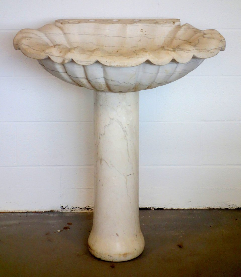 Marble sink with separate marble pedestal - sink in the: Marble sink with separate marble pedestal - sink in the form of a sea shell. Probably mid to late 20th century. 32"W x 24"D x 35"H.