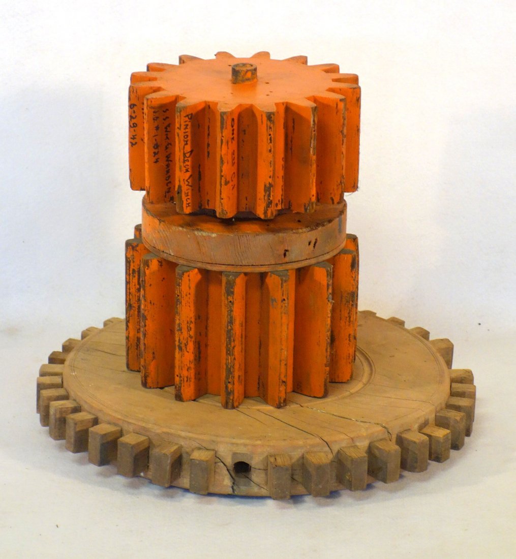 Grouping of 3 wooden architectural wooden gear wheels,: Grouping of 3 wooden architectural wooden gear wheels, 2 in orange paint - 8.5"D - early 20th century - and 1 natural - 16"D (missing several teeth) - 18th/18th century.