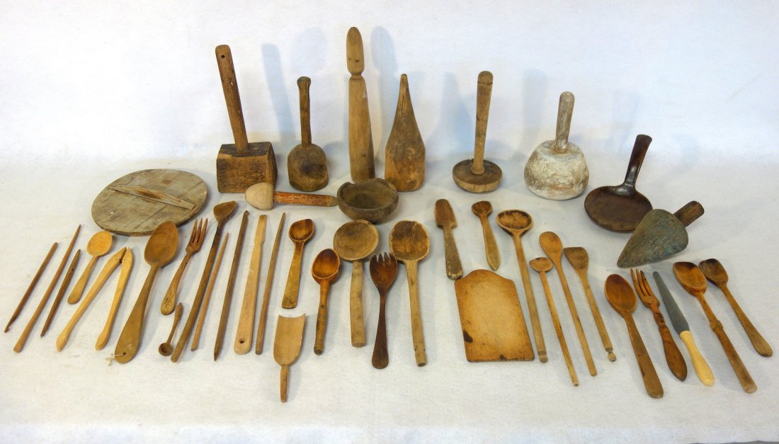 Large grouping of early wooden kitchenware including: Large grouping of early wooden kitchenware including spoons, ladles, mortars, primitive mortars, butter scoop, etc.