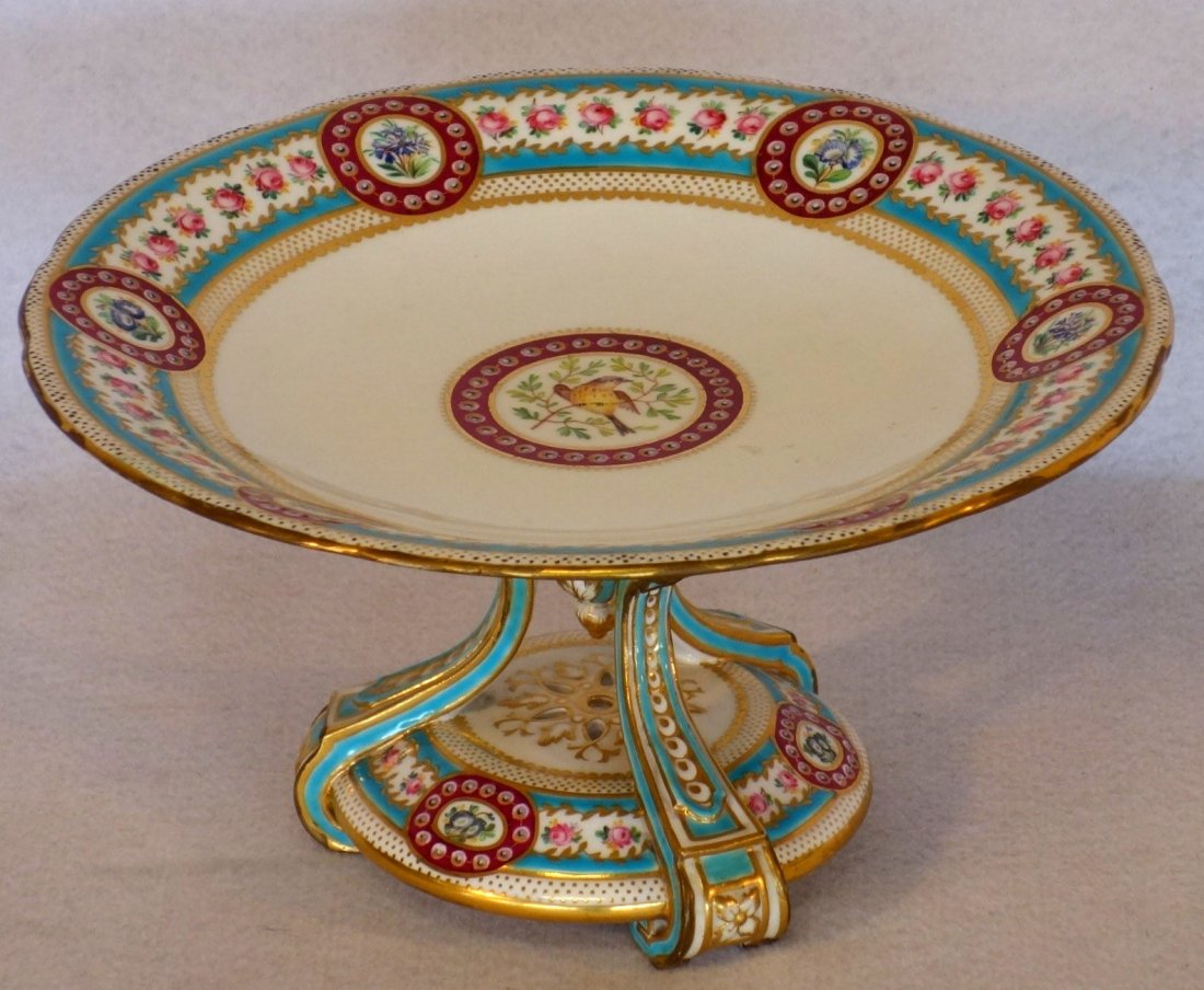 Fancy signed Minton cake plate on pedestal with hand: Fancy signed Minton cake plate on pedestal with hand painted bird as central medallion and hand painted floral border and hand painted scrolled floral open work base with gold highlights. Late 19th to