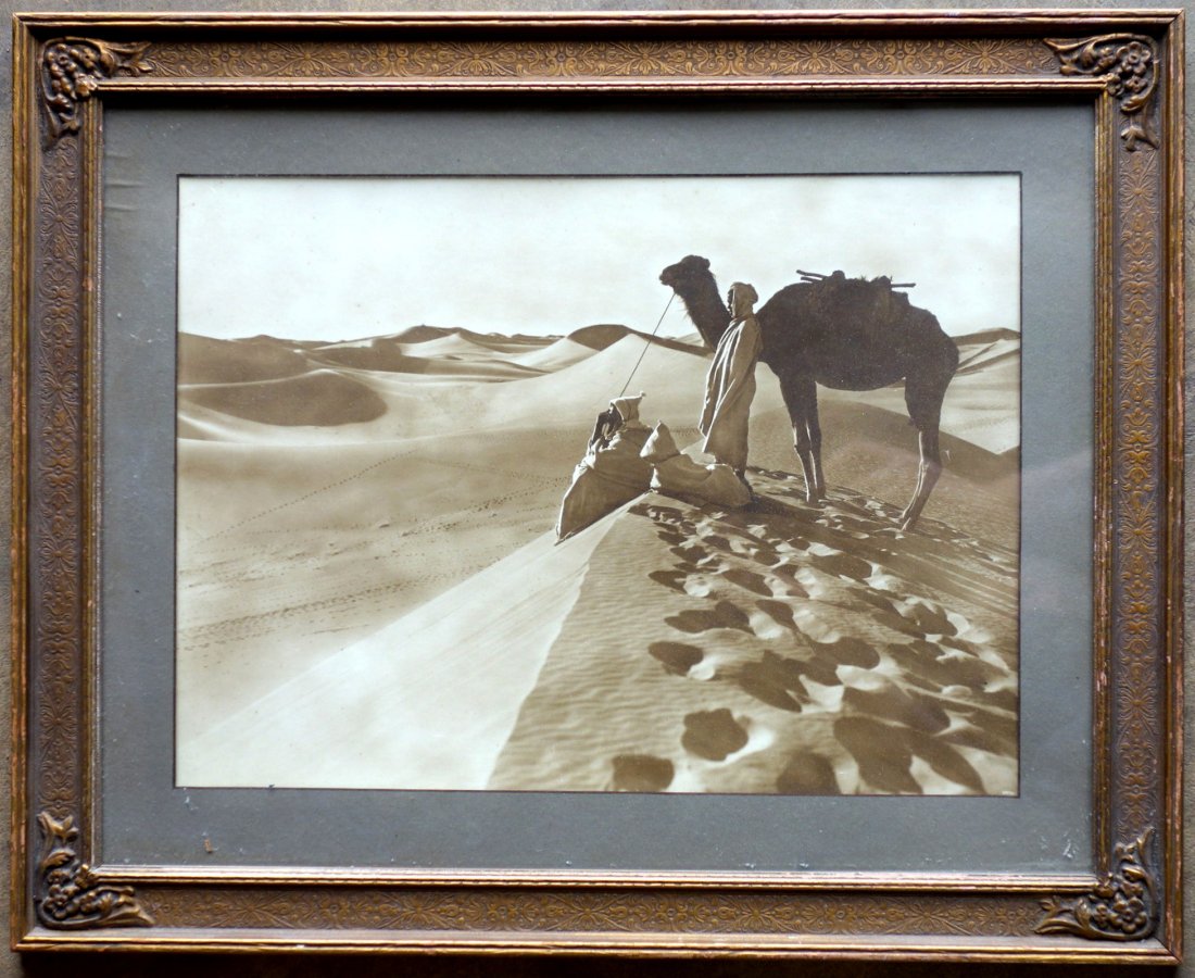 Art Deco framed photo of camel & men in desert.: Framed photo of 2 Middle Eastern gentleman with camel in desert - appears to retain original Art Deco era frame. 11" x15". Very good condition.