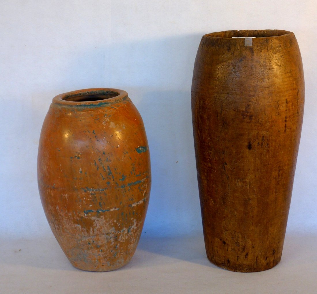 Two large primitive storage vessels including one hand: Two large primitive storage vessels including one hand dug wood (replaced bottom) probably 18th century - 25.5"H and a glazed redware jar - 19"H, probably 19th century - slight hairline, otherwise goo