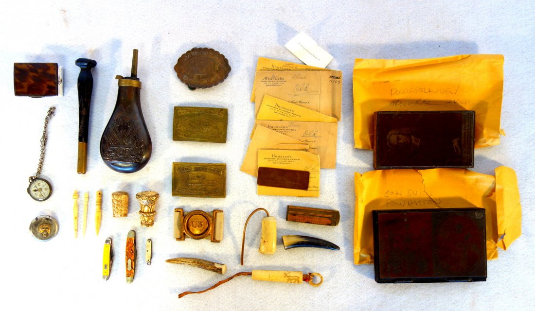 Grouping of decorative items including printing block: Grouping of decorative items including printing block of John Smith and Native Americans, 2 Wells Fargo and 1 Liberty Bell brass belt buckles, jack knives, compass, bone carvings, State Dept. Business