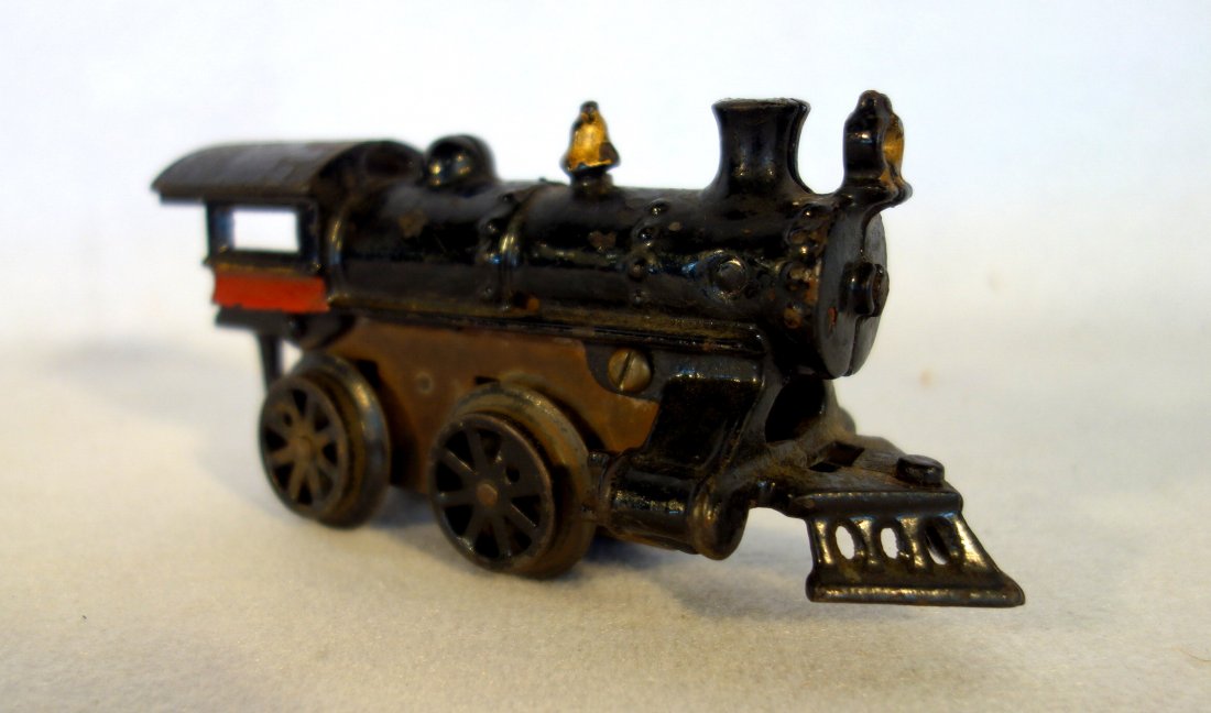 Windup clock works cast iron steam engine in original: Windup clock works cast iron steam engine in original black and red paint - good condition but non-working (spring may be broken) - 7"L.