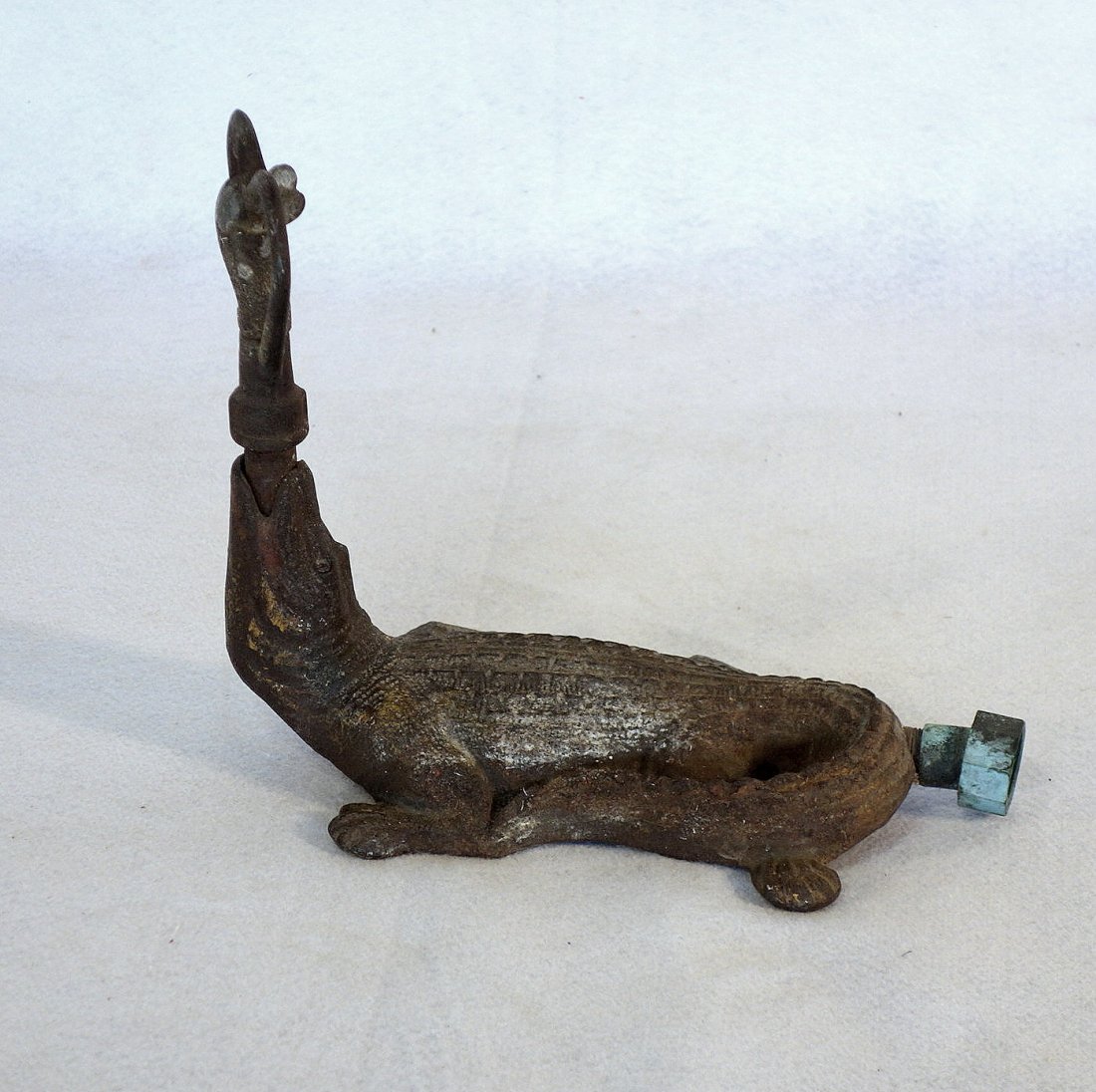 Cast iron alligator form lawn sprinkler, traces of: Cast iron alligator form lawn sprinkler, traces of original red and yellow paint with heart shaped sprinkler - great detail. Circa 1920. 11"L x 9"H.