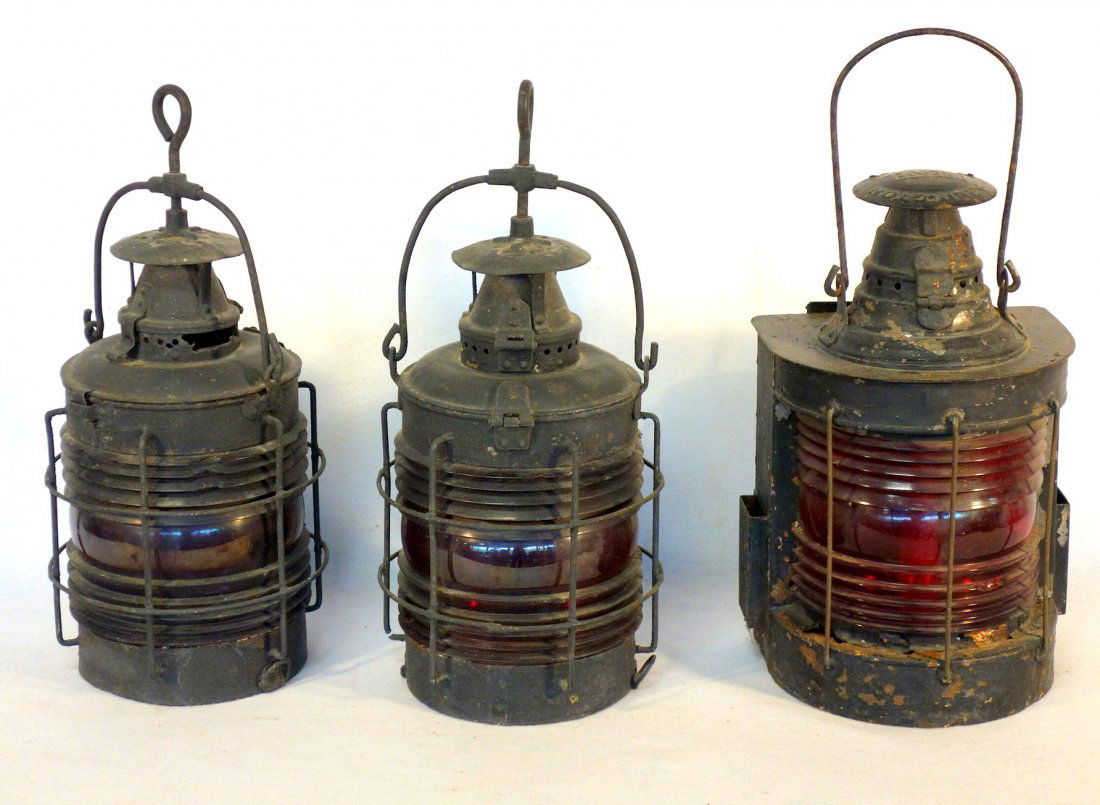 Grouping of 3 old iron lanterns including 2 matching: Grouping of 3 old iron lanterns including 2 matching Adlake marine lanterns with red lenses - approximately 20"H - old black paint, some chips to lenses, rusted bottom; together with a large Arlington