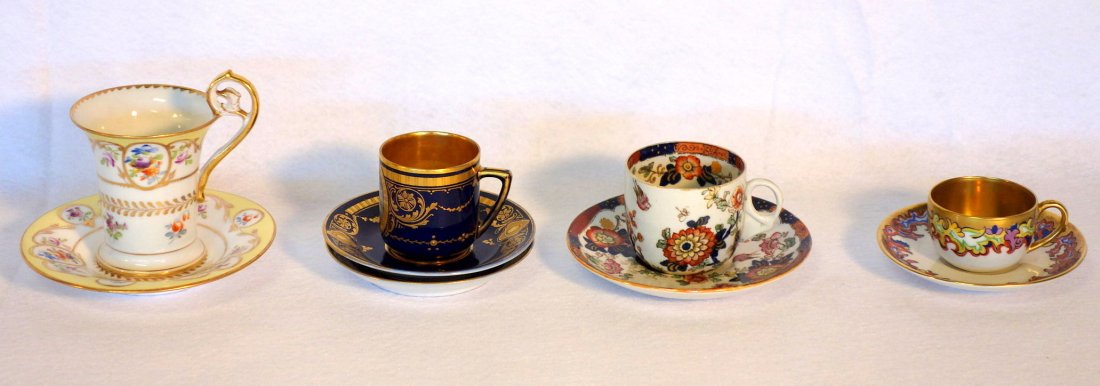 Grouping of 4 demitasse cups and saucers including: Grouping of 4 demitasse cups and saucers including signed KPM, Mason's Ironstone, Dresden, and one with beehive mark in cobalt blue and gold decorations with a hand painted scene of lady with cherub (