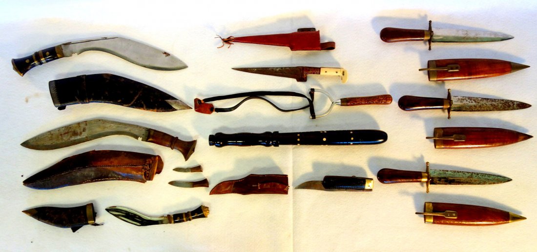 Grouping of 7 Middle Eastern style daggers (1 with 2: Grouping of 7 Middle Eastern style daggers (1 with 2 attached miniature daggers), an usual folding knife with carved handle and original leather case, 1 sling shot with carved wooden handle, and 1 ros