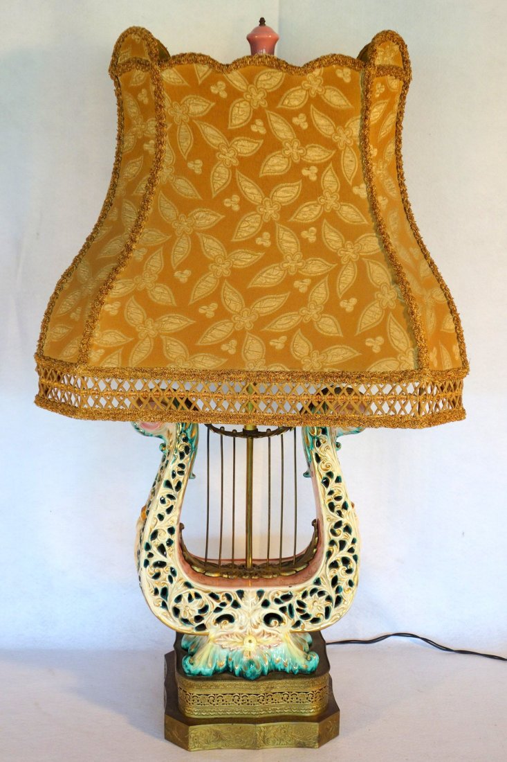 Hand painted Capodimonte lyre shaped porcelain table: Hand painted Capodimonte lyre shaped porcelain table lamp on ornate pressed metal base with brass finish, probably early 20th century - the sides of the lamp decorated with embossed nude ladies. Origi