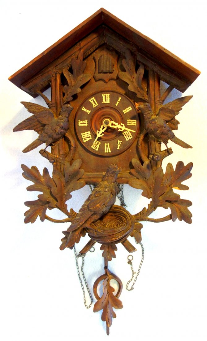 Black Forest cuckoo clock: Black Forest cuckoo clock with 3 carved birds on oak leaf branches with acorns - one bird on nest - All 3 birds with losses to beaks, minor losses to leaves including pendulum - also missing weights -