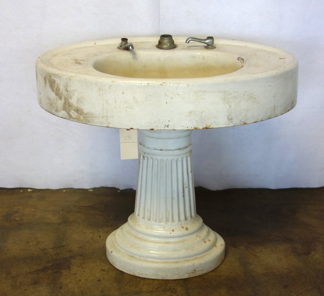 White enameled cast iron sink on fluted pedestal - 5": White enameled cast iron sink on fluted pedestal - 5" loss to enamel on edge of sink - missing most hardware. 32.5"L x 22"D x 29.5"H. Probably early 20th century.