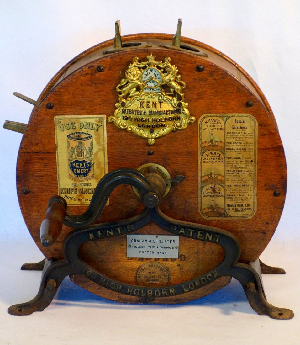 English table top cylindrical oak knife sharpener: English table top cylindrical oak knife sharpener signed on ornate pressed copper plaque Kent Patentee & Manufacturer / 199 High Holborn / London. Has original paper labels on sides as well as origina