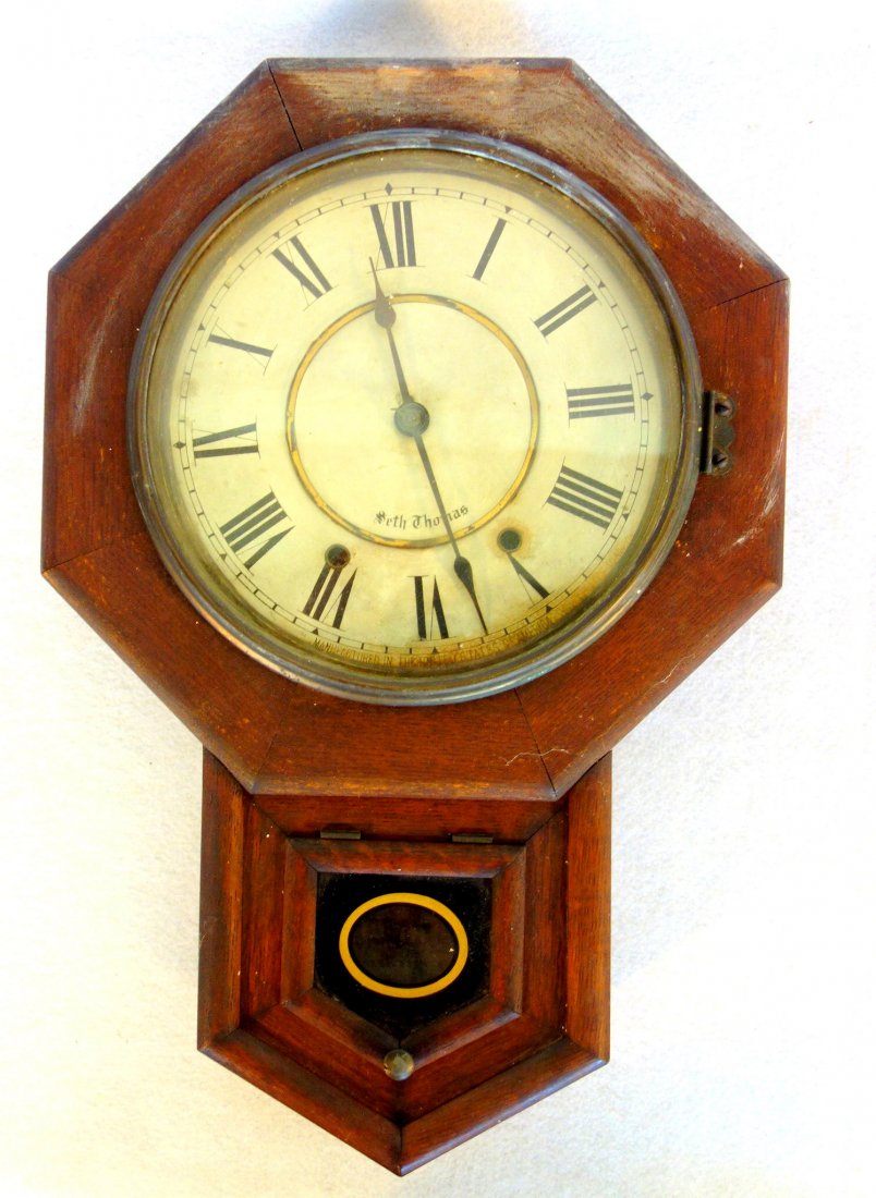 Seth Thomas oak school house clock with key and: Seth Thomas oak school house clock with key and pendulum. Original finish.