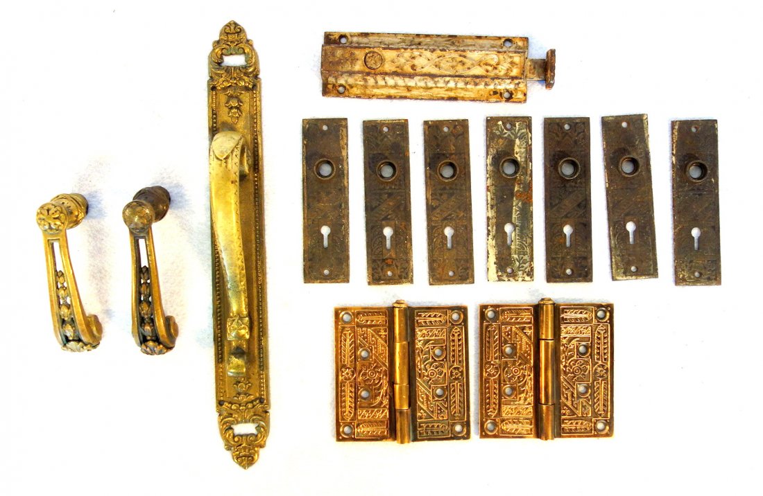 Grouping of Victorian door hardware including pair of: Grouping of Victorian door hardware including pair of brass door handles, a large single brass door handle with back plate - 15"H, a cast iron latch, 2 matching brass hinges, and 7 lock plates. All in