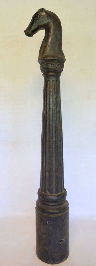 Folk art cast iron horse head hitching post on fluted: Folk art cast iron horse head hitching post on fluted column. Slight loss to tips of both ears of the horse, otherwise very good condition. Mid 19th century. 44"H.