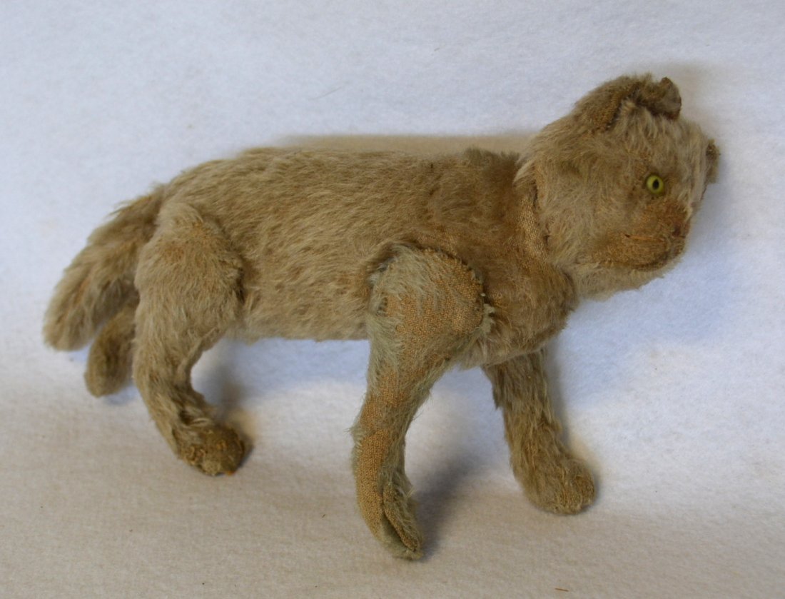 Mohair cat with yellow glass eyes and articulated legs: Mohair cat with yellow glass eyes and articulated legs and head, probably Steiff - late 19th to early 20th century - some wear, but overall very good condition. 8"L x 6"H.