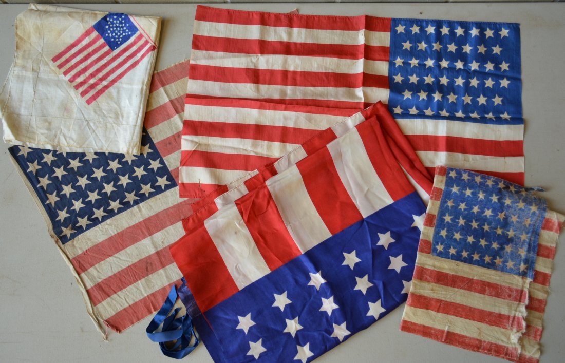 Five small American flags: 1) Printed 42 star cotton: Five small American flags: 1) Printed 42 star cotton flag - 23"L - slight fraying around perimeter, otherwise good condition; 2) Printed 44 star flag - starched gauze fabric - 17.5"L - loss to 1 star 