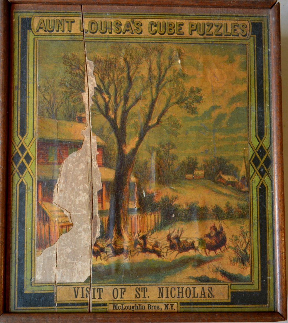 Block puzzle in original box "Aunt Louisa's Cube: Block puzzle in original box "Aunt Louisa's Cube Puzzles / Visit of St. Nicholas / McLoughlin Bros. NY", circa 1900. Thirty wooden cubes lined with chromolithograph images that form the puzzles in ori
