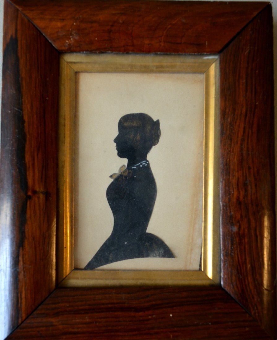 Cut silhouette of a young lady with water color: Cut silhouette of a young lady with water color highlights - sight size 3" x 4.5" - very good condition - Signed on reverse Mrs. John D. Simpson. Early 19th century.