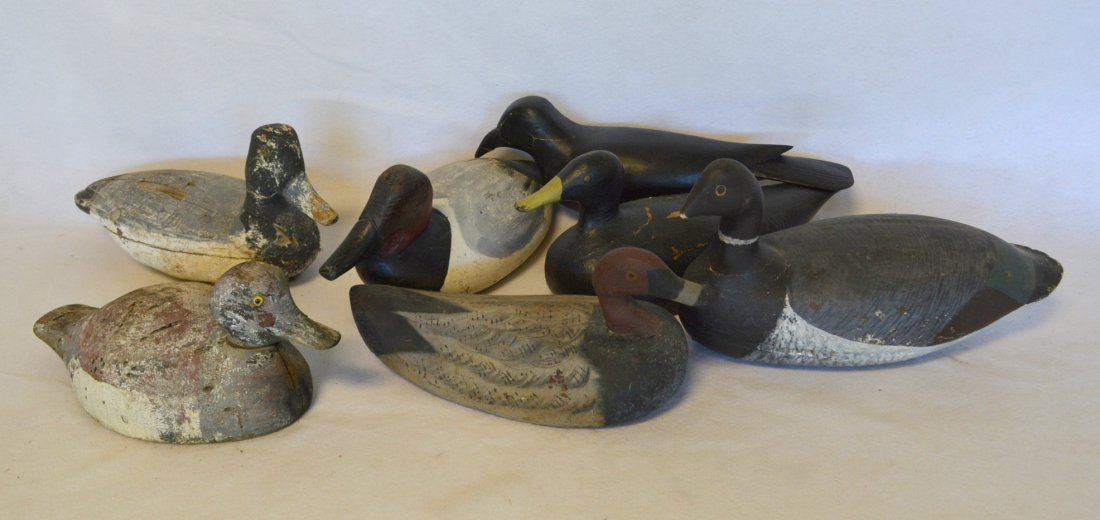 Grouping of 6 primitive decoys & 1 crow. Most with: Grouping of 6 primitive decoys & 1 crow. Most with wear, losses and weathering and in fair condition.