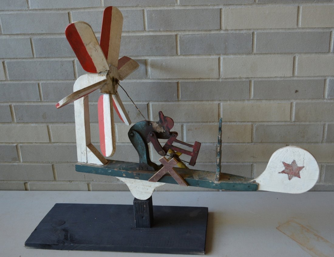 Folk art whirligig of man sawing log in original paint: Folk art whirligig of man sawing log in original paint - 23.5"L x 22"H. Very good original condition. Mounted on custom made wooden stand. Mid 20th century.