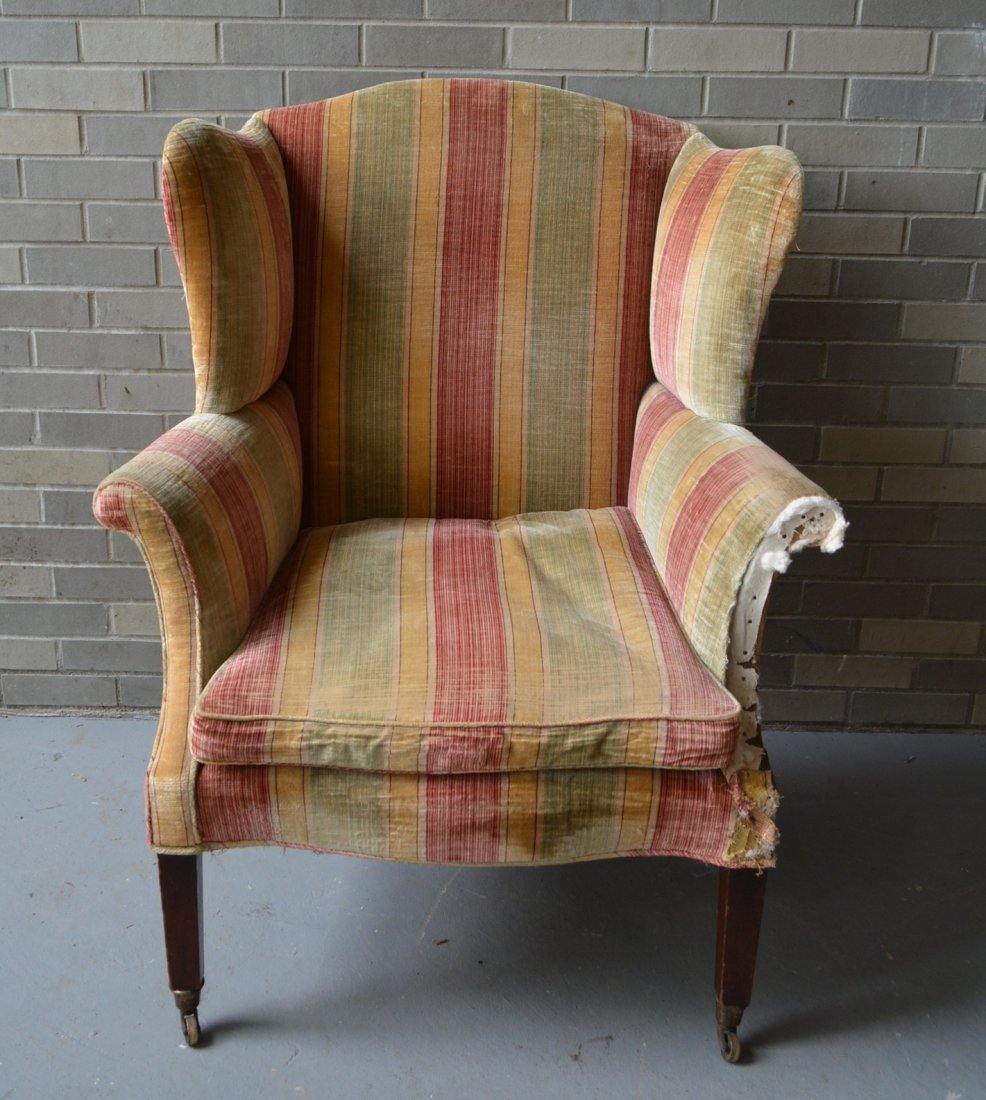 Country Hepplewhite wing chair, tapered front legs in: Country Hepplewhite wing chair, tapered front legs in mahogany, with rosehead nail construction and old possibly original brass fitted casters. Good original finish and good structural condition. New 