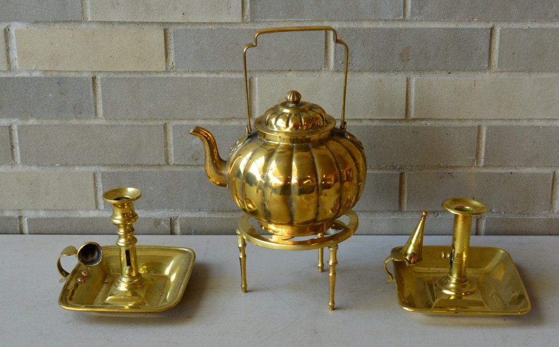 Grouping of 4 early brass items including 2 good: Grouping of 4 early brass items including 2 good chamber sticks with removable candle snuffers, a brass tri-leg trivet, and a melon shaped goose neck tea kettle with swivel handle. All 18th/19th centu