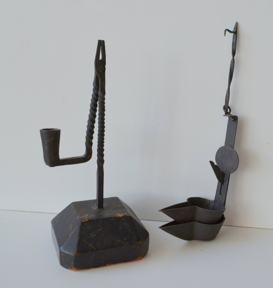 Two early lighting devices including hand forged iron: Two early lighting devices including hand forged iron rush lamp on original chamfered wooden base with original finish - 10"H, and a double Betty lamp with original hand forged hanger - 6.25"H (exclud