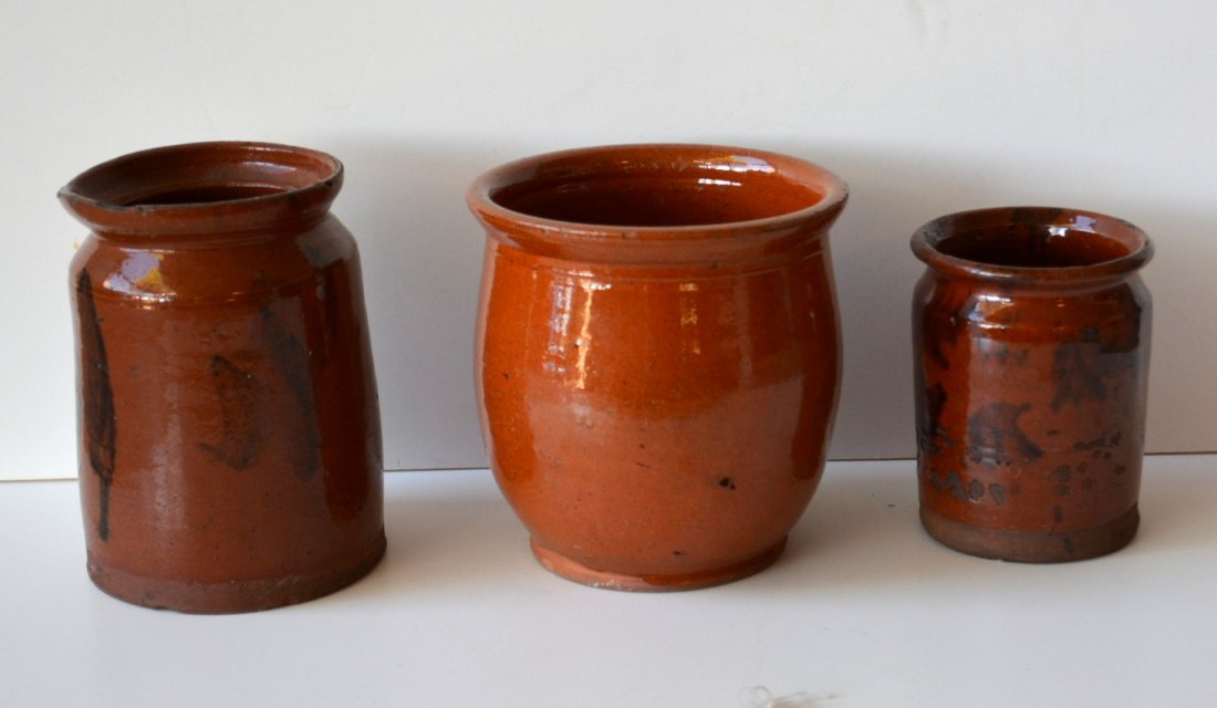 Three redware jars: 1) The smallest with manganese: Three redware jars: 1) The smallest with manganese decorations 4.5"H - some glazing losses and small 1"L hairline extending from rim hardly noticeable; 2) Manganese decorated jar - 6.25"H - 2 tiny rim