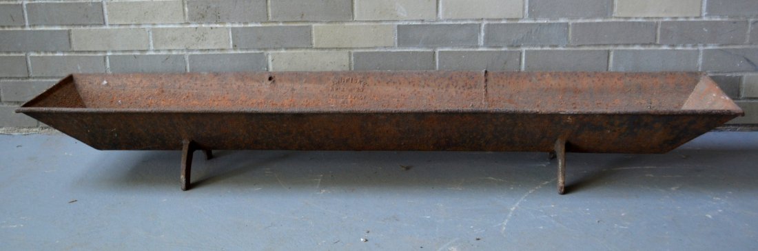 Cast iron pig trough signed J.W. Fiske No. 2. with: Cast iron pig trough signed J.W. Fiske No. 2. with horseshoe like feet - 60"L x 12"W x 8"H. Minor surface rust and pitting, missing 2 small iron lifting supports, otherwise good structural condition. 