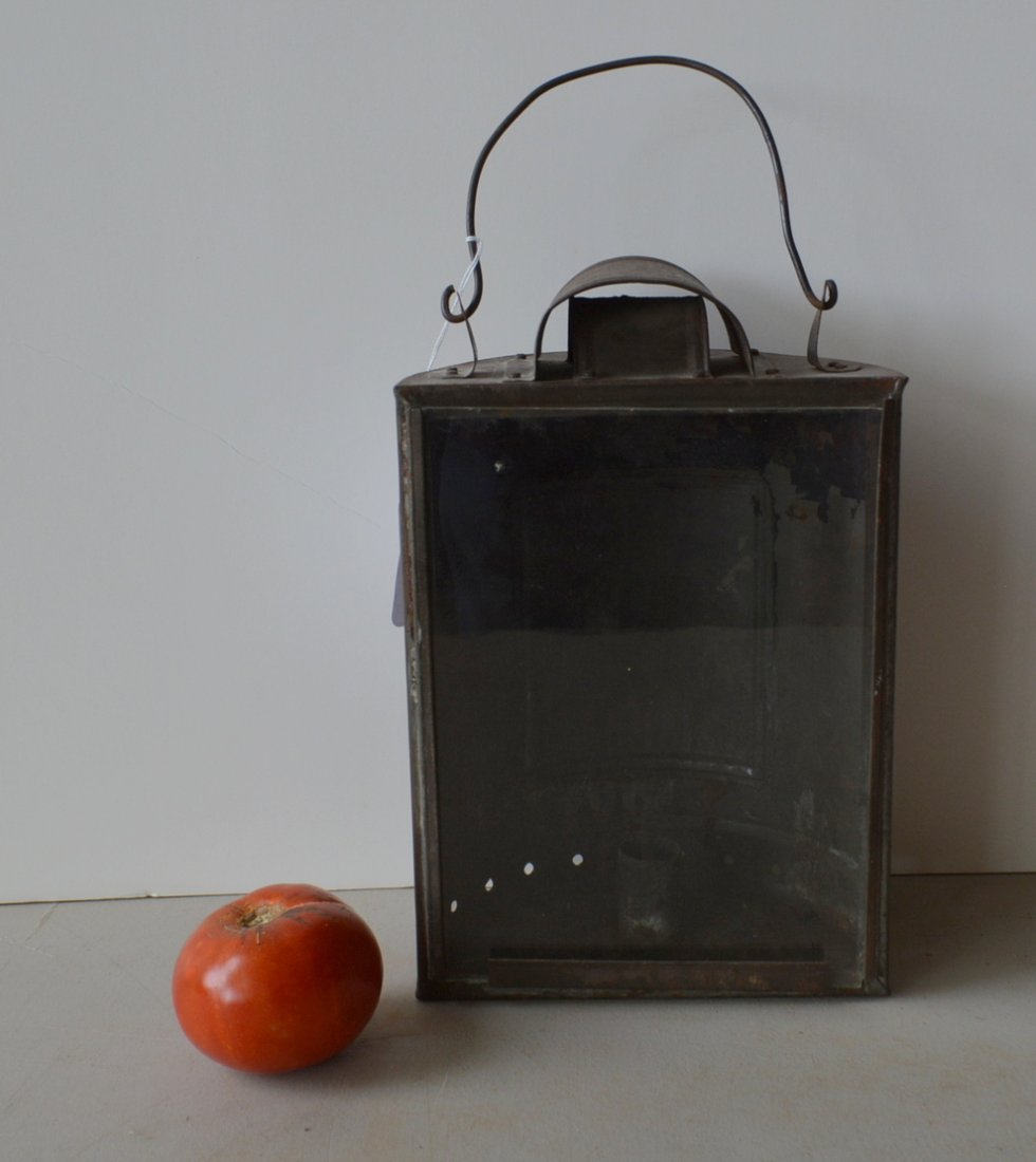 Early tin 1/2 round lantern with interior candle: Early tin 1/2 round lantern with interior candle socket, removal sliding glass panel, traces of old green paint, and bail handle - 11.5"H - early 19th century - minor use wear, overall very good condi