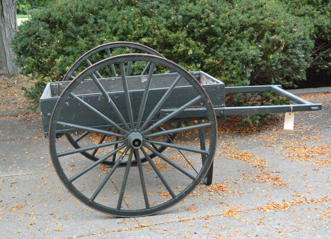 Early 2 wheel garden or flower cart, 19th c.: Hand drawn flower or garden cart with wooden wheels and wooden box, 19th century. Newer green paint over layers of old paint. Structurally sound and in good condition. 75"L x 47.5"W x 42"H.