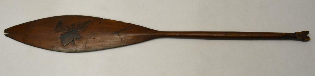 Old handmade canoe paddle decorated in relief  with a (1 of 7)