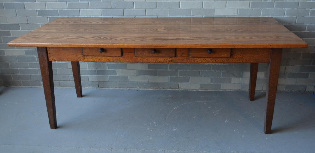 Old refinished farm table with a chestnut top and: Old refinished farm table with a chestnut top and having 3 drawers on the apron, one drawer on each end and heavy tapered legs. The apron also has a crusty varnish finish, all original to the piece. 7