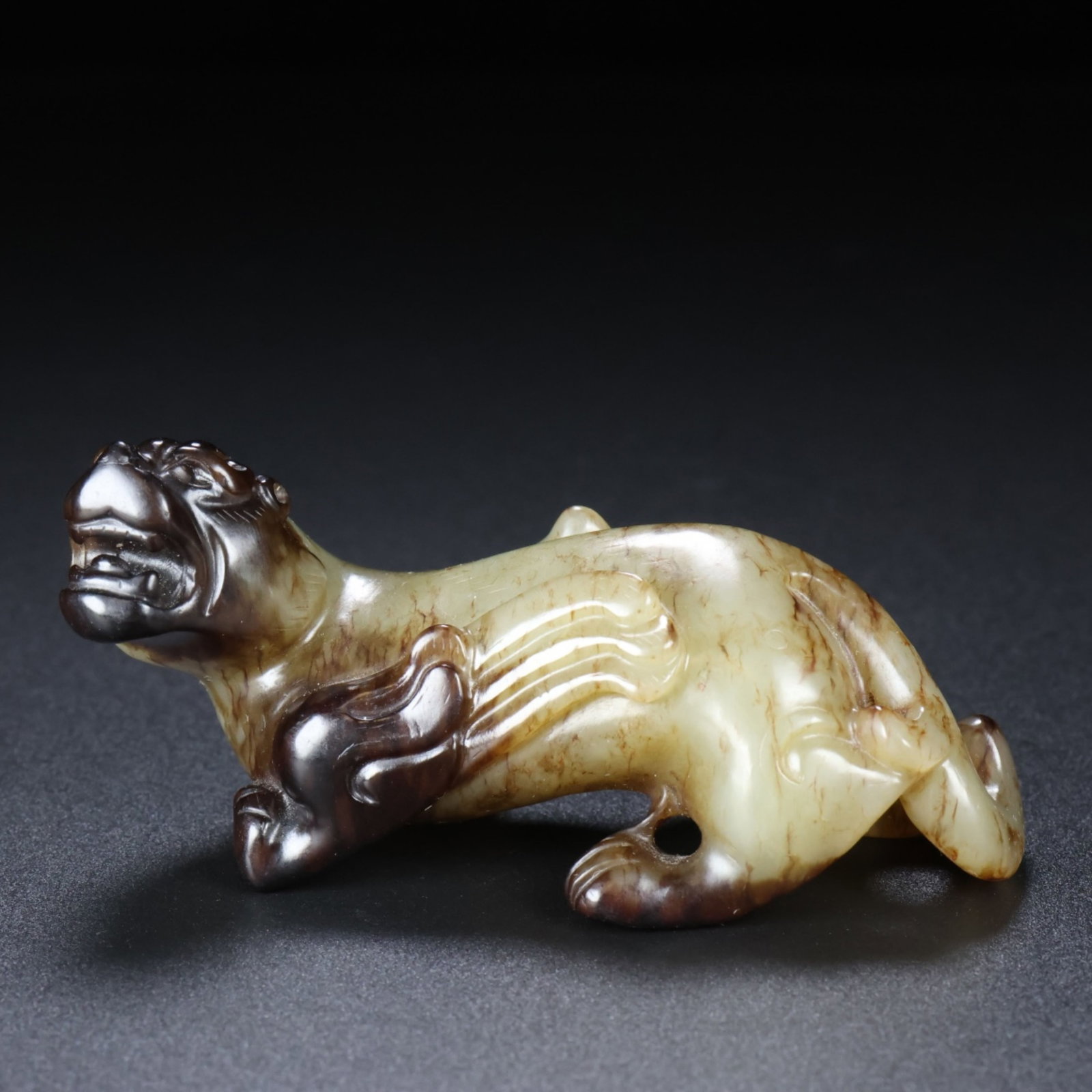A Chinese Carved Jade Foo-Dog: A Chinese Carved Jade Foo-Dog. Lg. 8cm, Wd. 3.5cm, Ht. 4cm, Wt. 102g