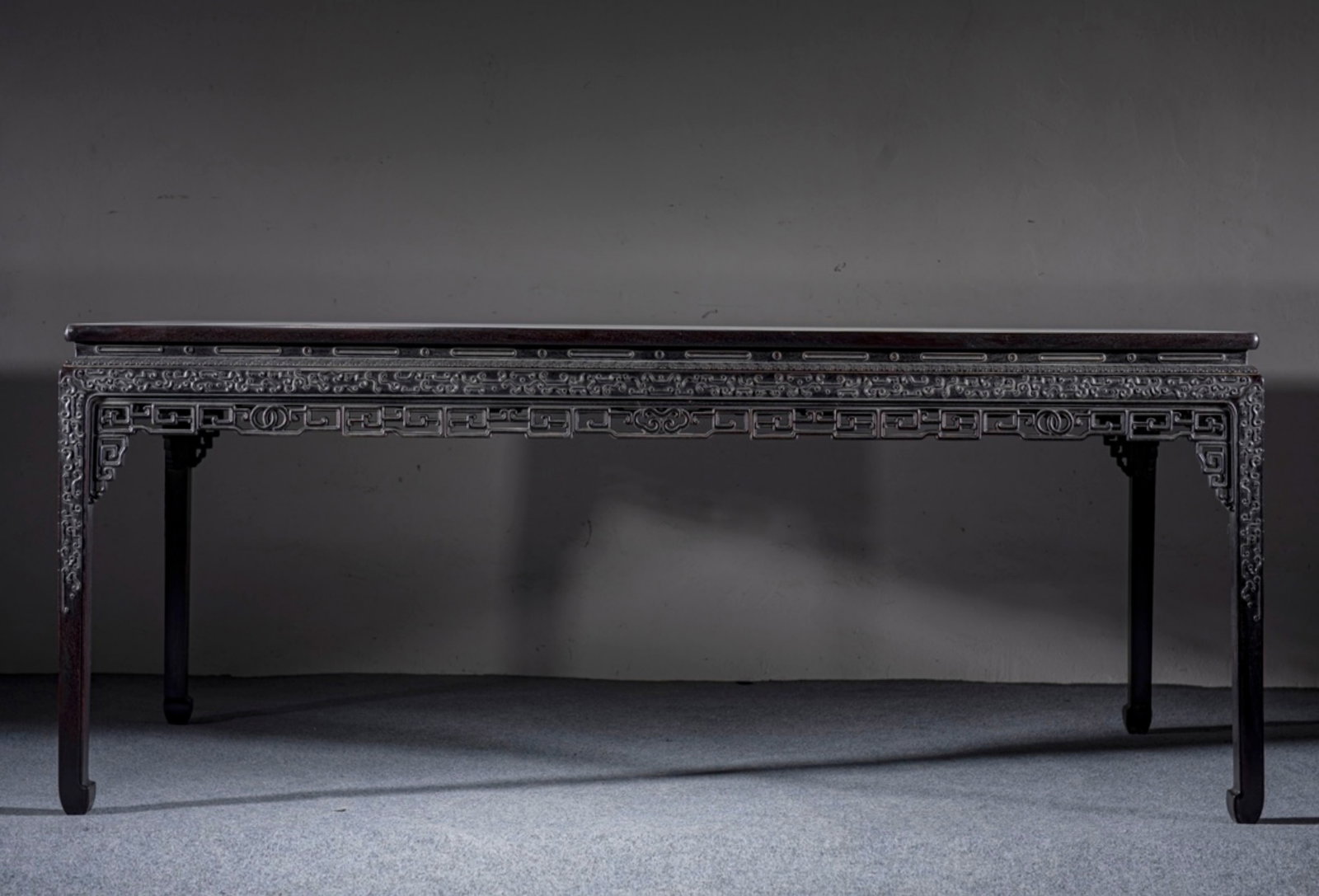A Chinese Carved Hardwood Table: A Chinese Carved Hardwood Table. Lg. 198cm, Wd. 88cm, Ht. 82cm