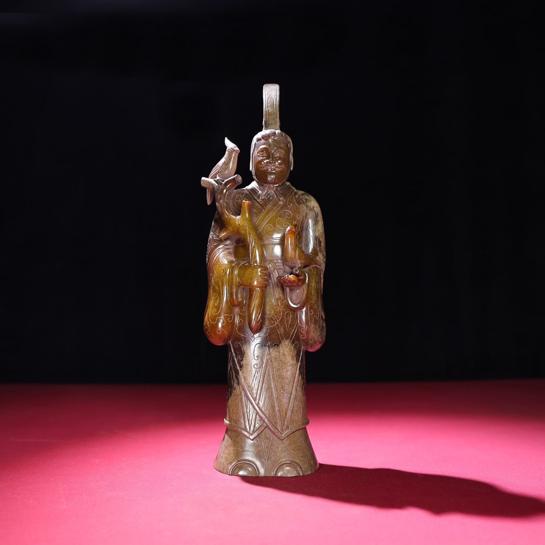 A Chinese Carved Jade Figure of Trainer with Bird: A Chinese Carved Jade Figure of Trainer with Bird. Ht. 33.1cm, Wd. 10cm, Th. 6.2cm, Wt. 2199g