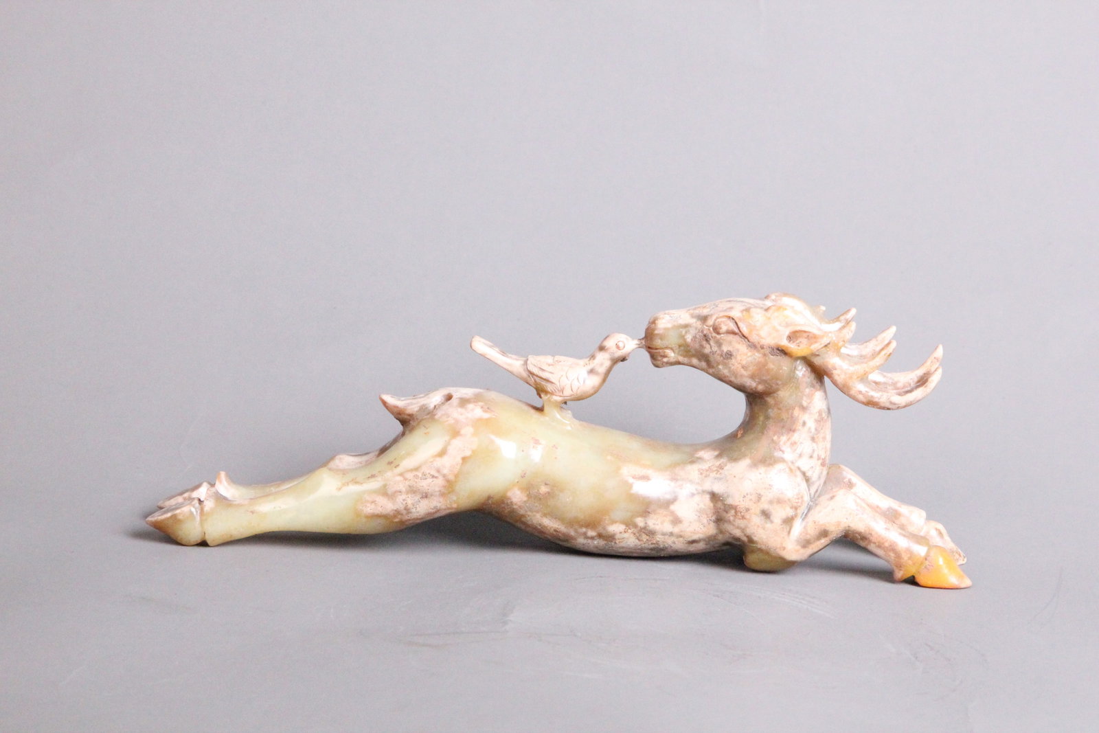 A Chinese Carved Jade Deer Statuette: A Chinese Carved Jade Deer Statuette. Lg. 21.3cm