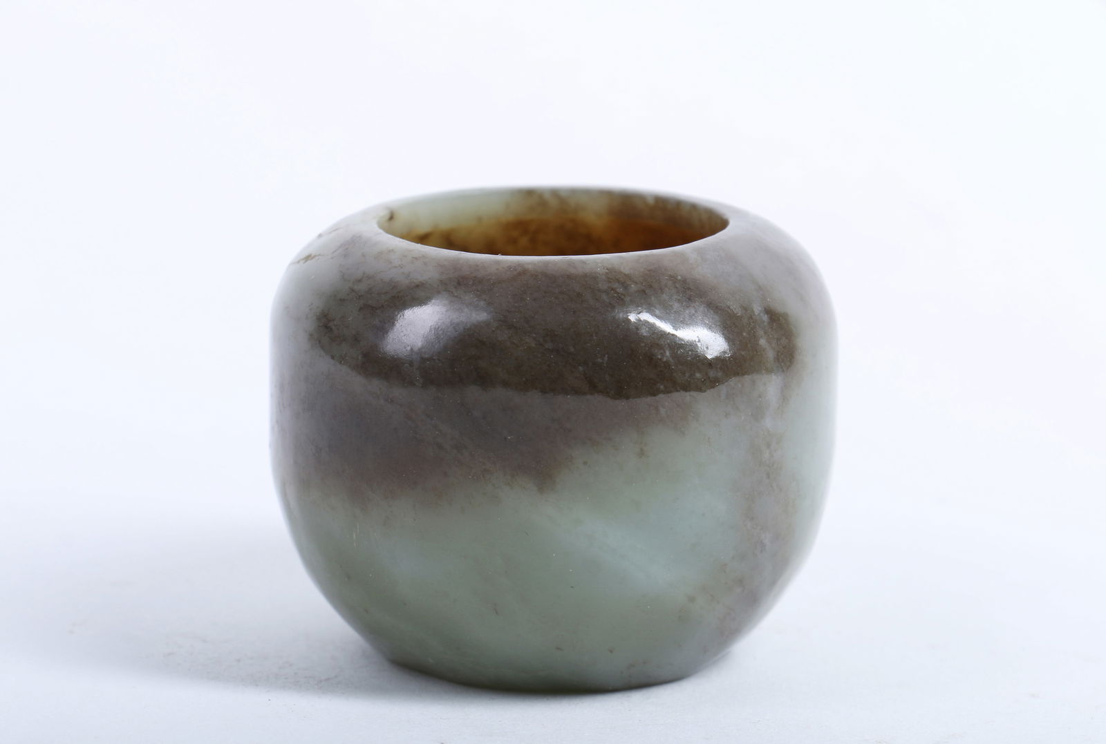 A Carved Jade Water Pot: A Carved Jade Water Pot. Ht. 5cm, Max Diam. 6.2cm, Wt. 174g